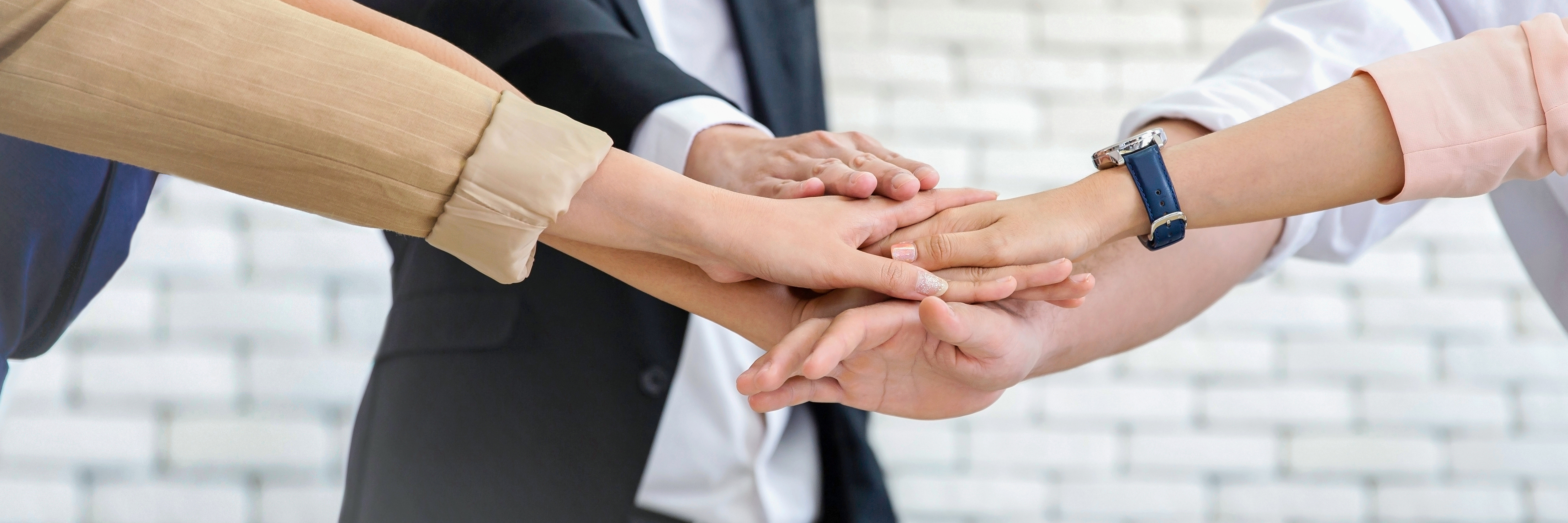 Business team stacking hands in unity